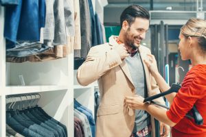 Couple buying clothes at department store.